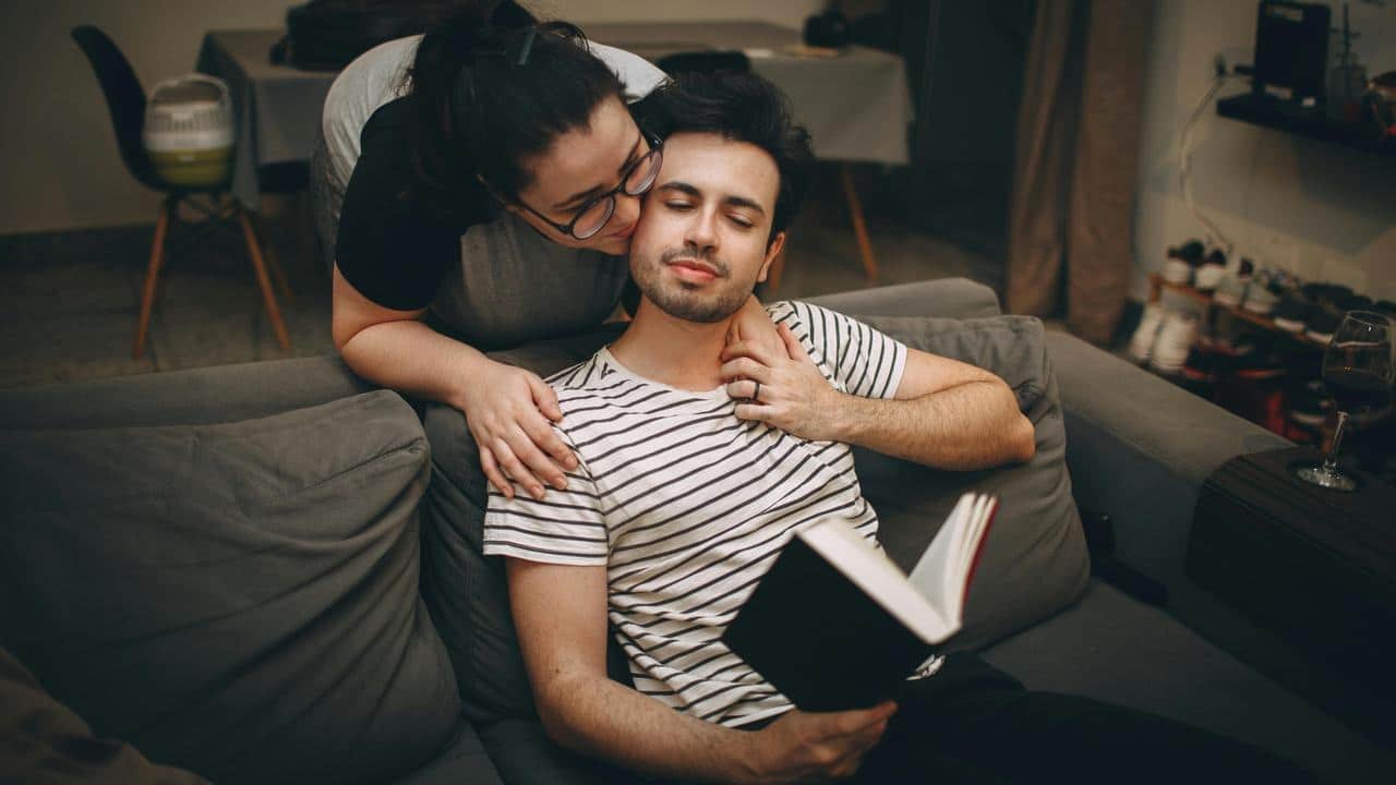 A woman kissing a man on the cheek