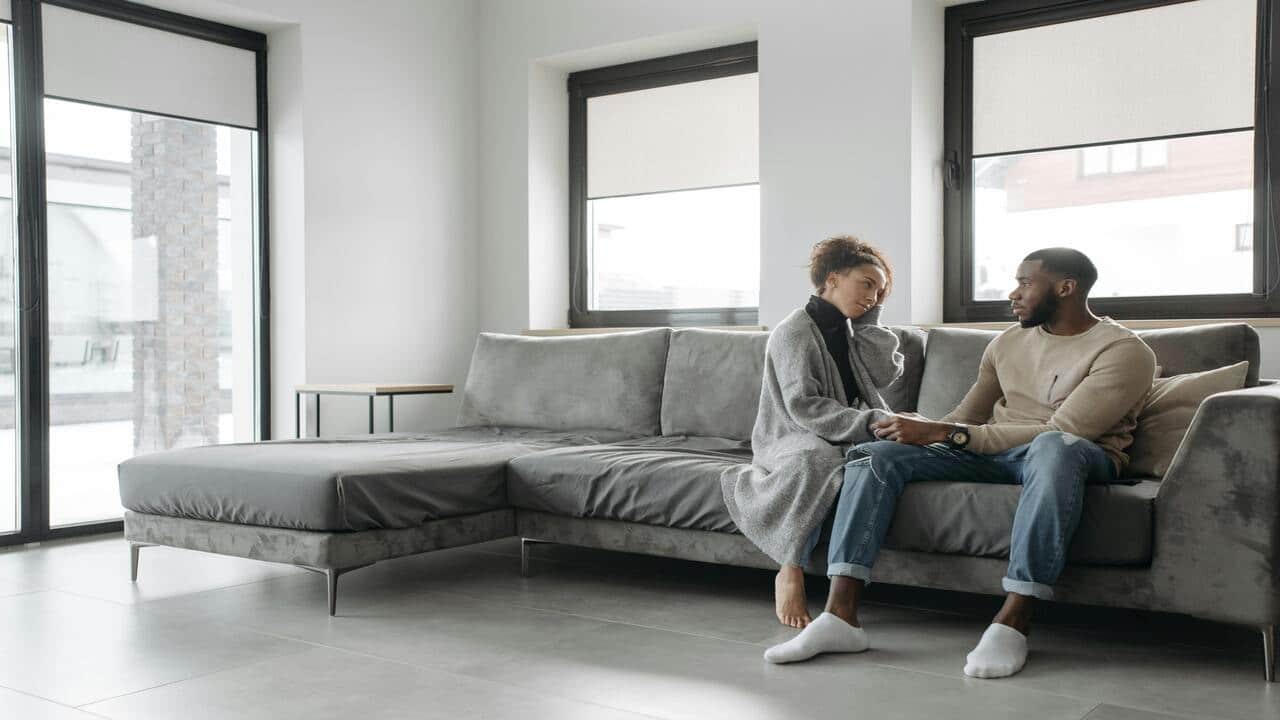 A couple talking in the living room