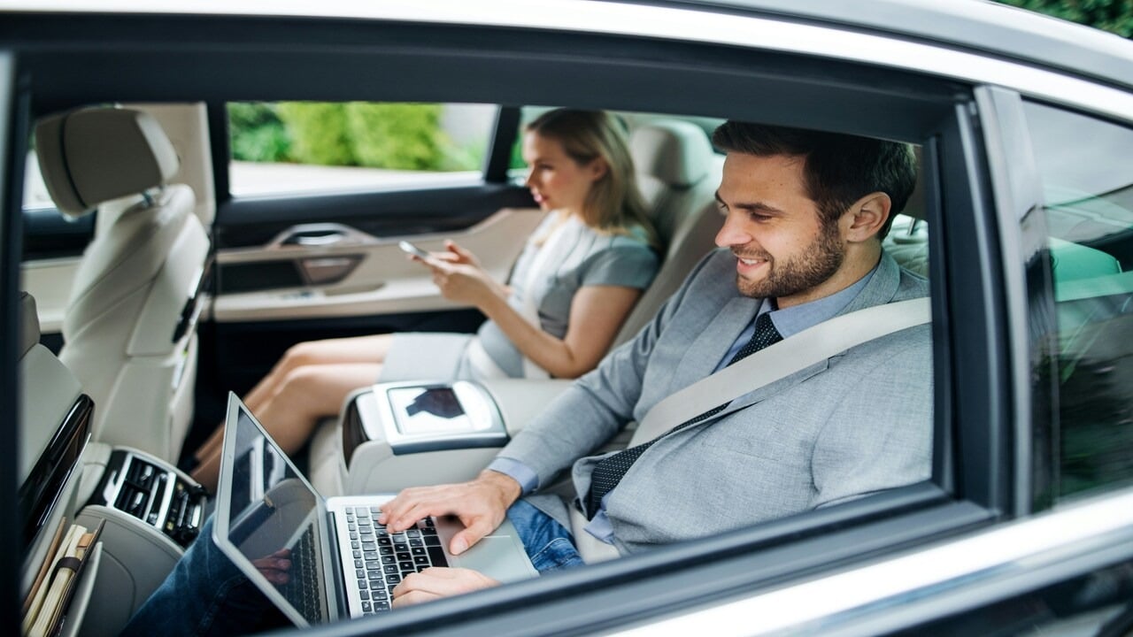 A couple in the backseat of a car