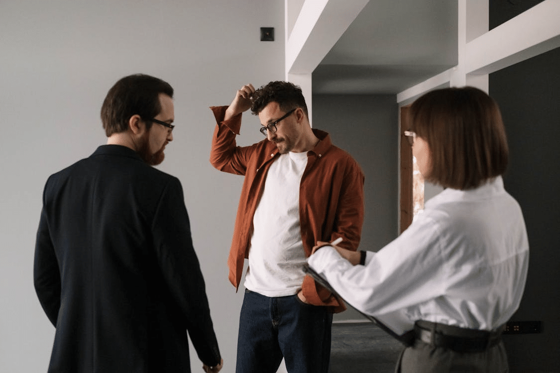 Man in Brown Long Sleeves Scratching His Head