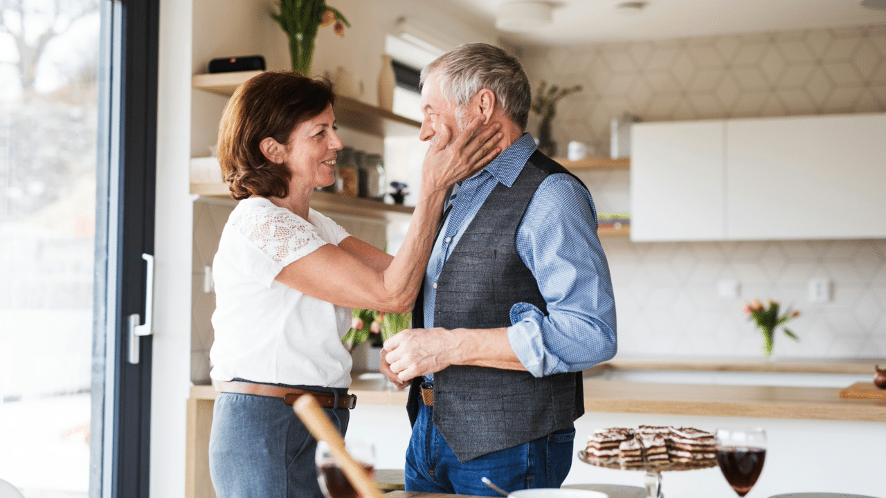 A mature couple smiling at each other