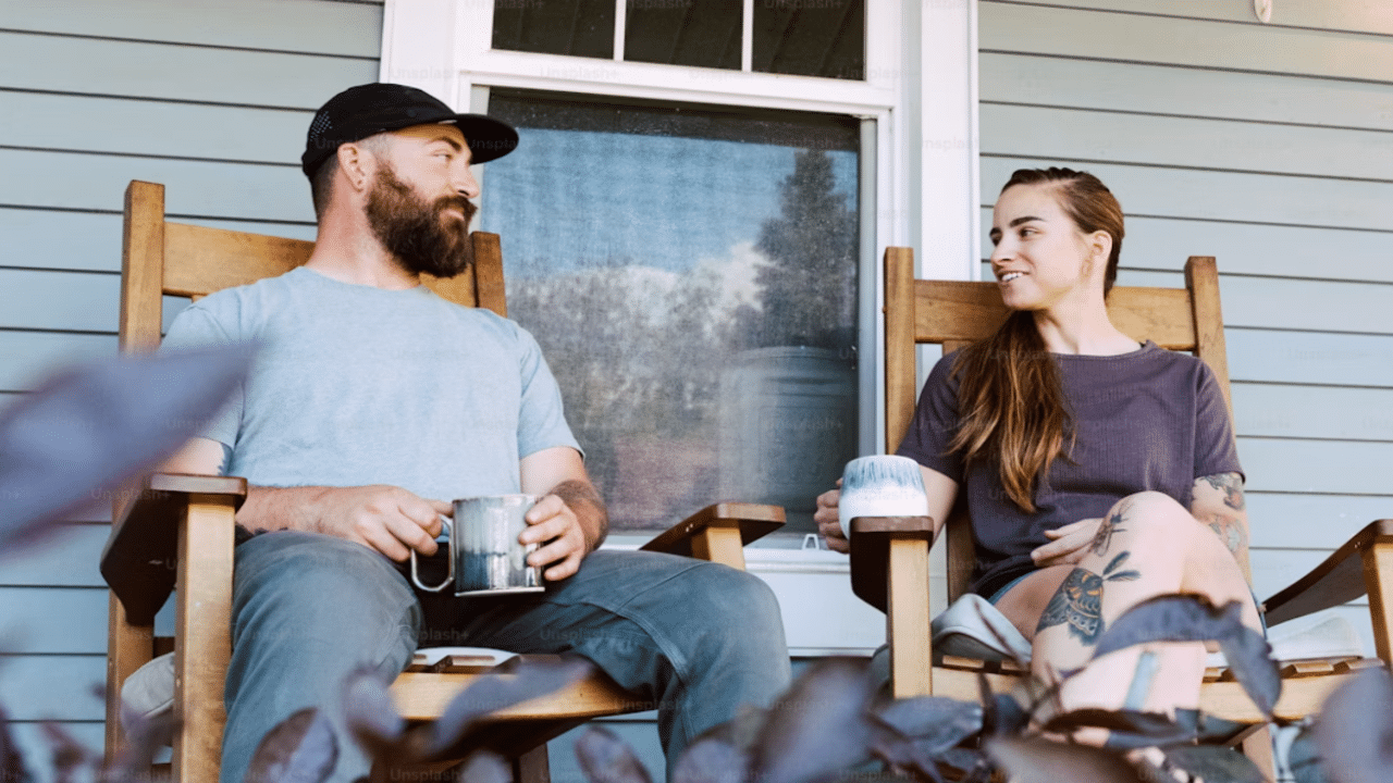 A couple talking on the porch