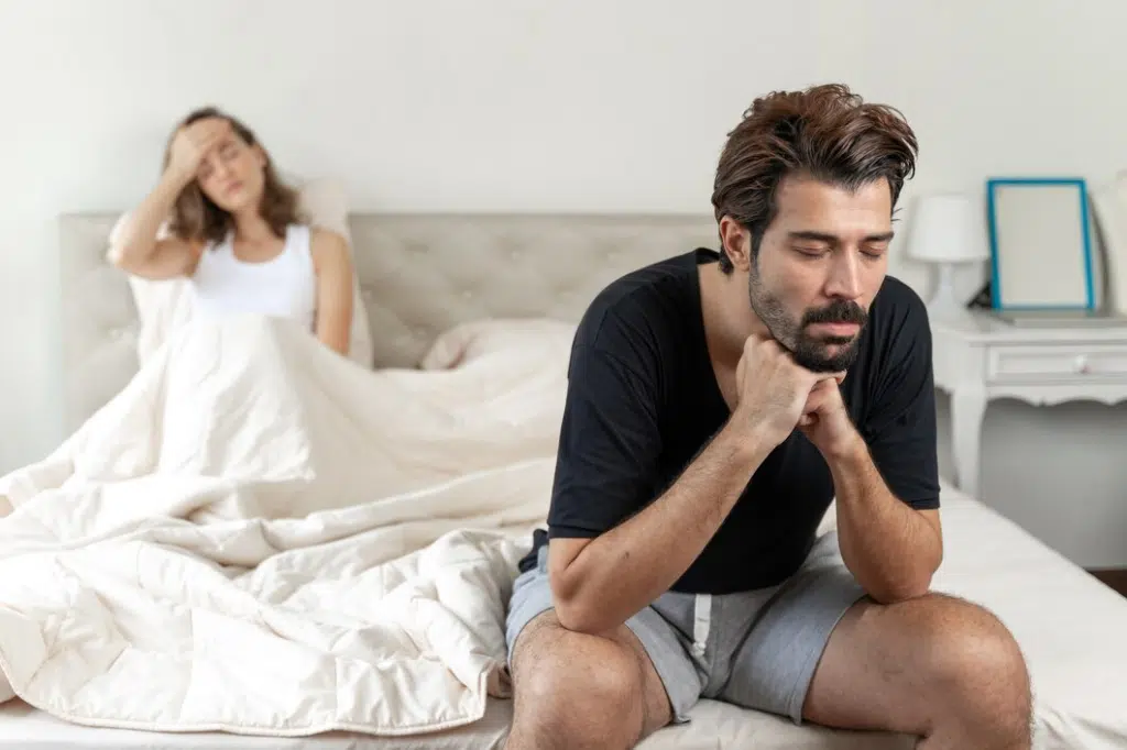 Selective husband sitting on bed