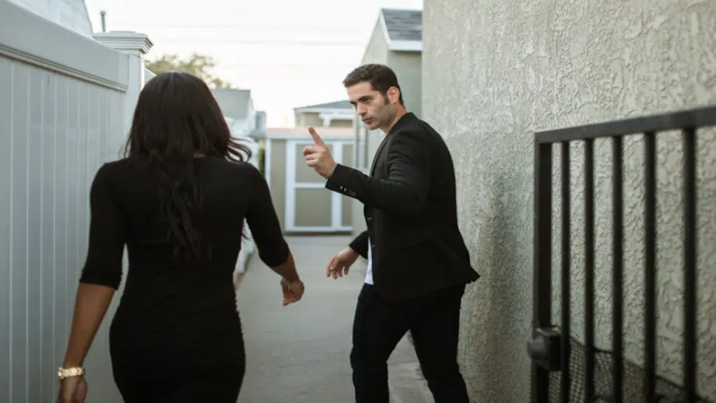 A couple fighting outside their home