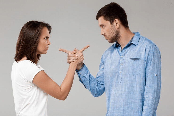 Couple having an argument and pointing at each other