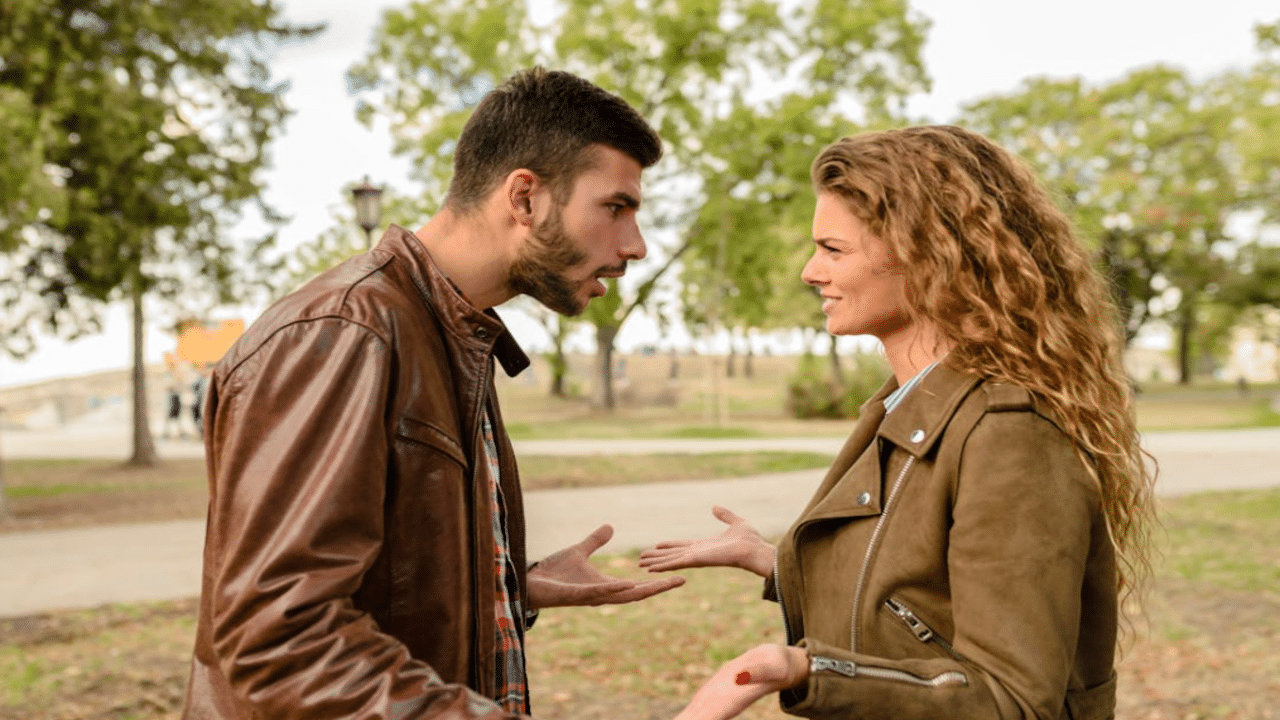 A couple fighting outdoors