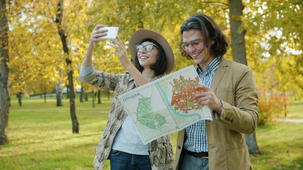 A couple looking at a map in the park