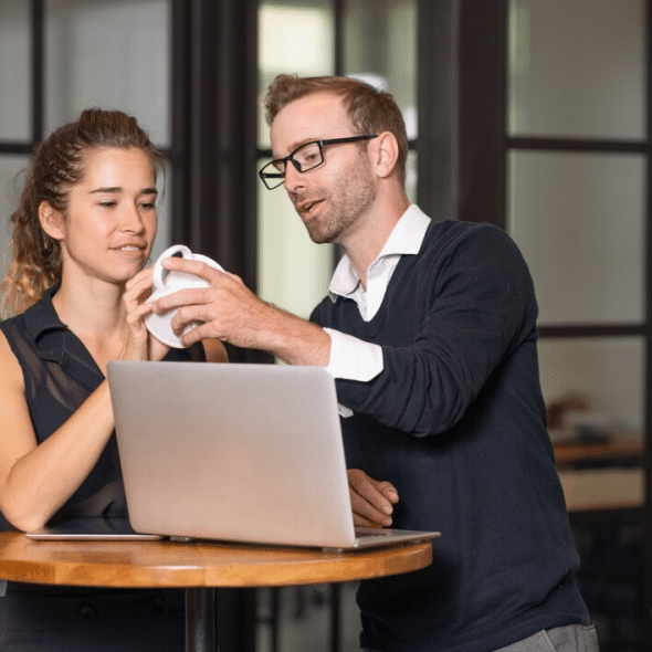 Business partners chatting and working at cafe table