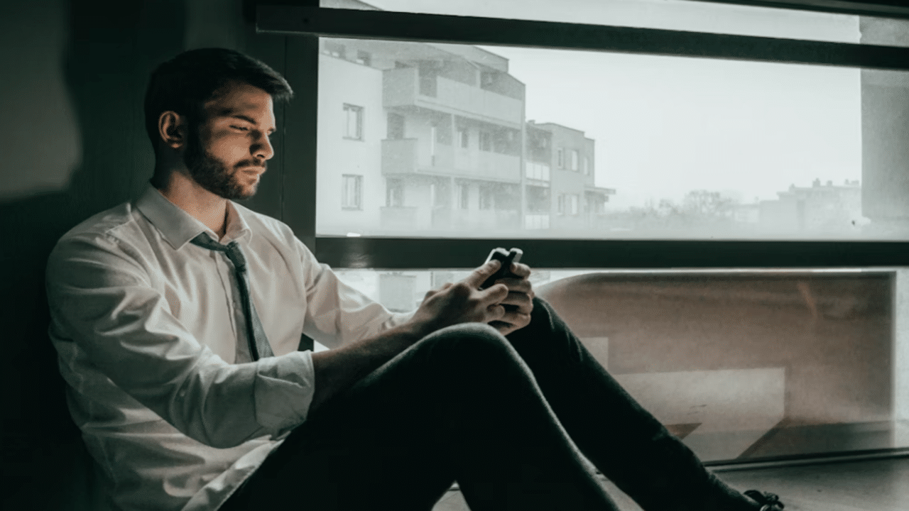 A man looking sad while texting