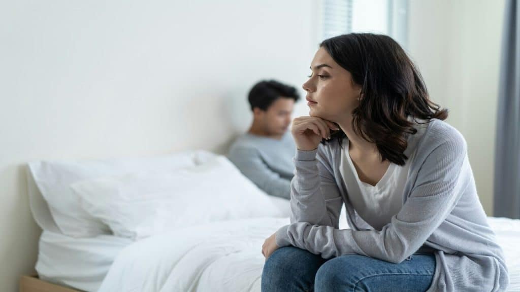 A couple ignoring each other in bed