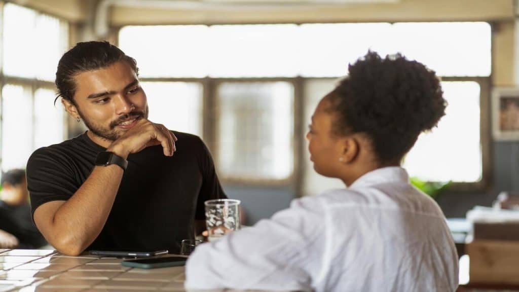 A couple talking at a cafe