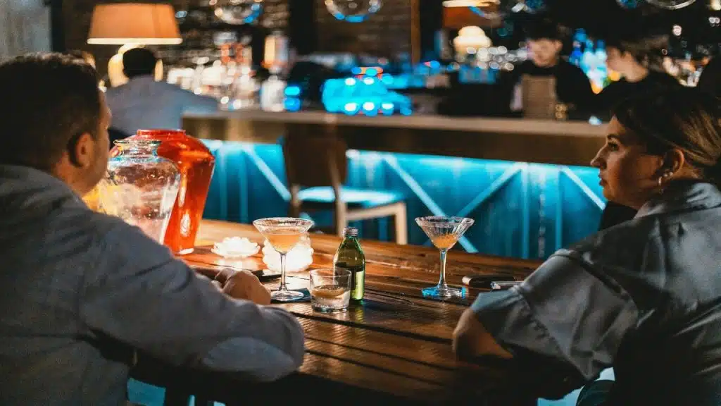 A man and a woman at a bar