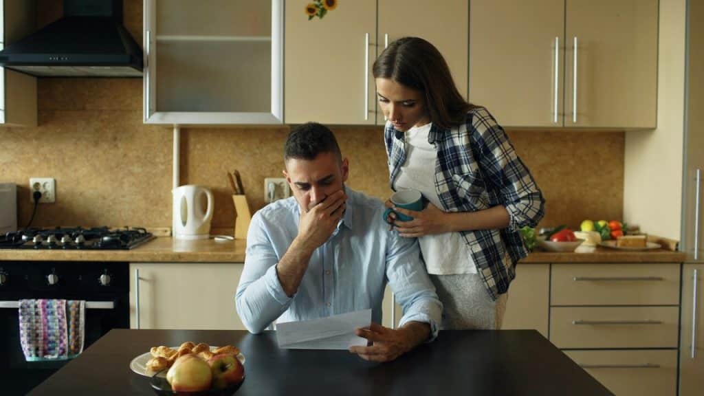 A couple looking stressed by the bills