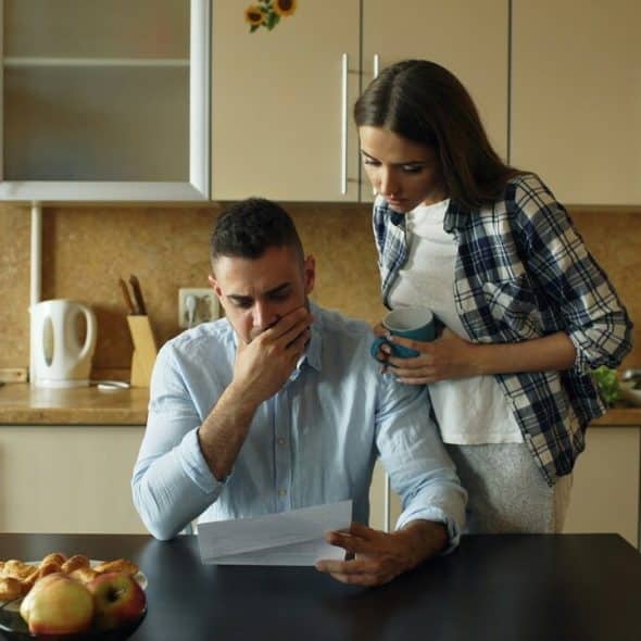 A couple looking stressed by the bills