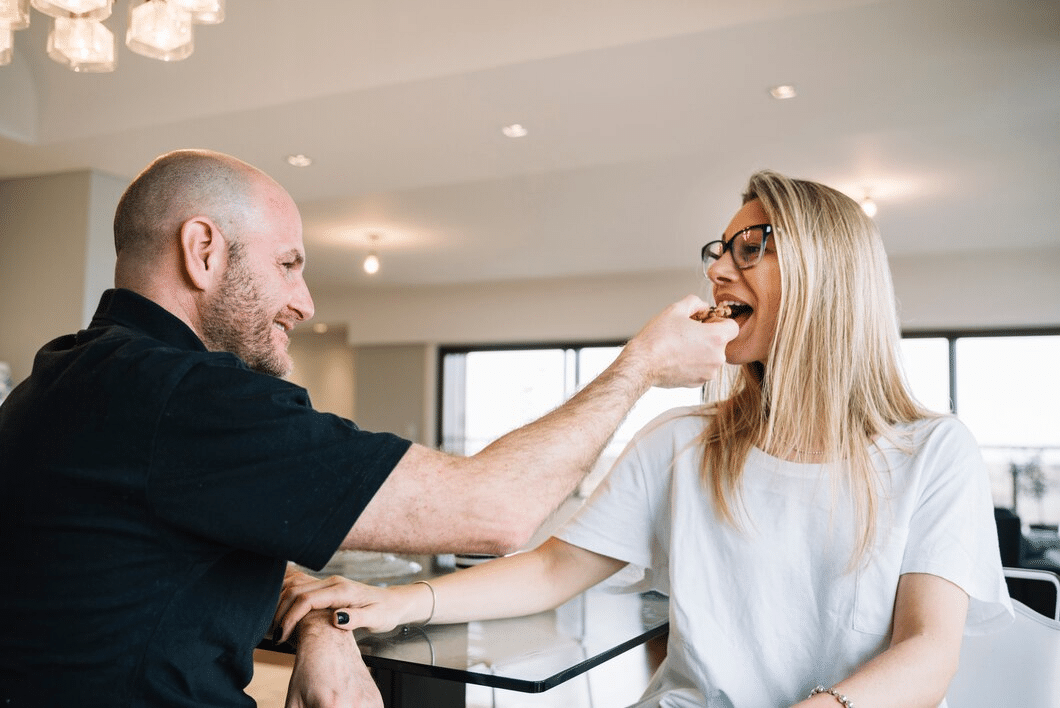Middle-aged couple in a workplace setting flirting