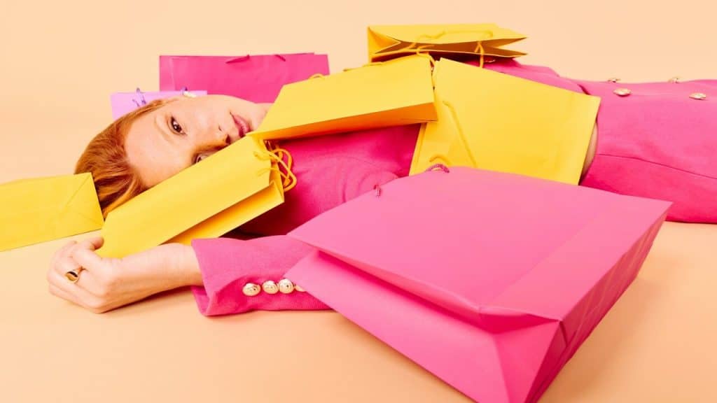 A woman on the ground with a lot of shopping bags