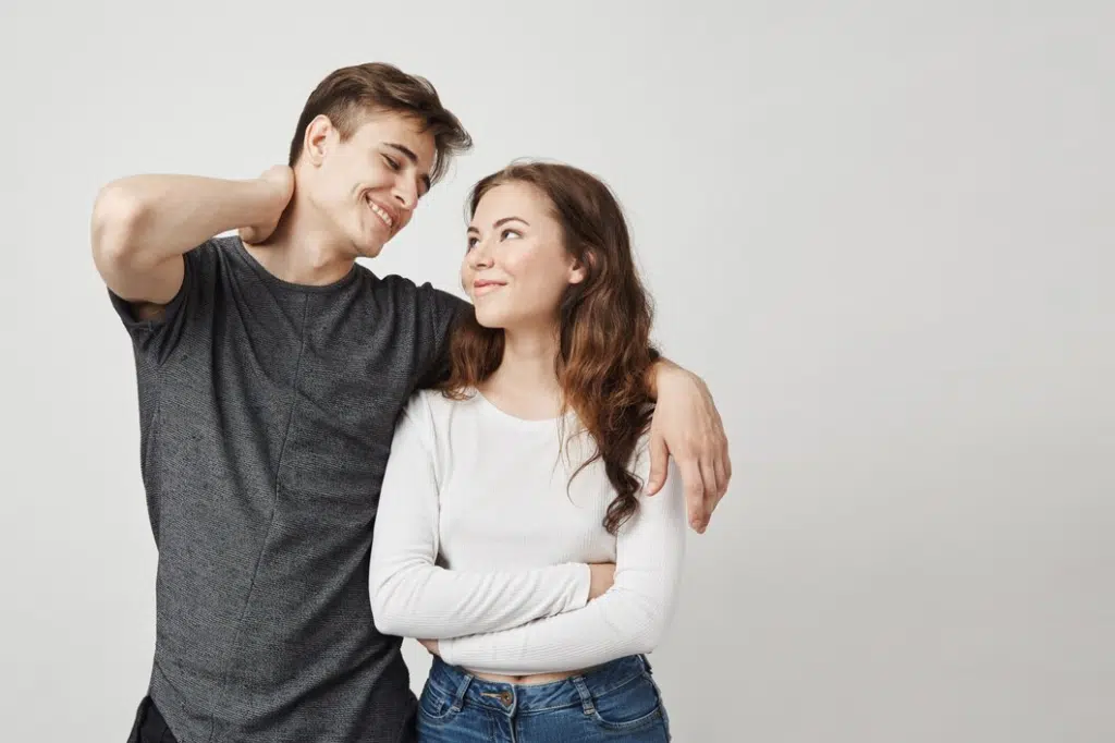Young beautiful young couple in love hugging and looking