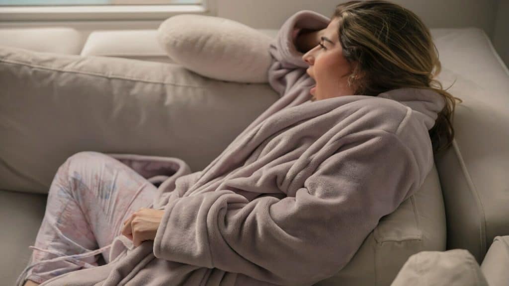A woman yawning at home