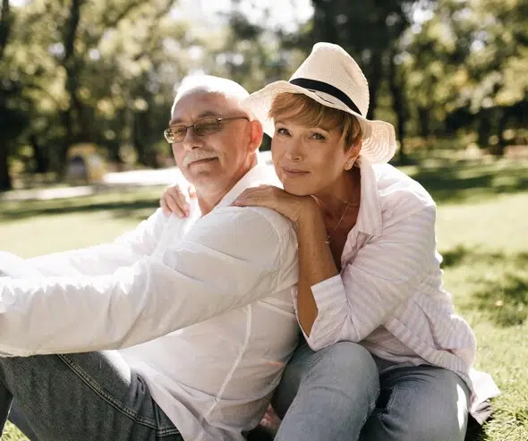 Mid-age couple sitting in park