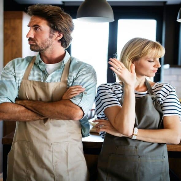 A couple fighting in the kitchen