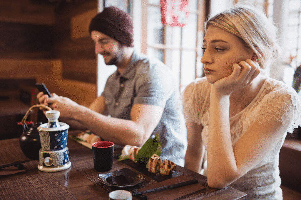 A man still using a phone while on a date
