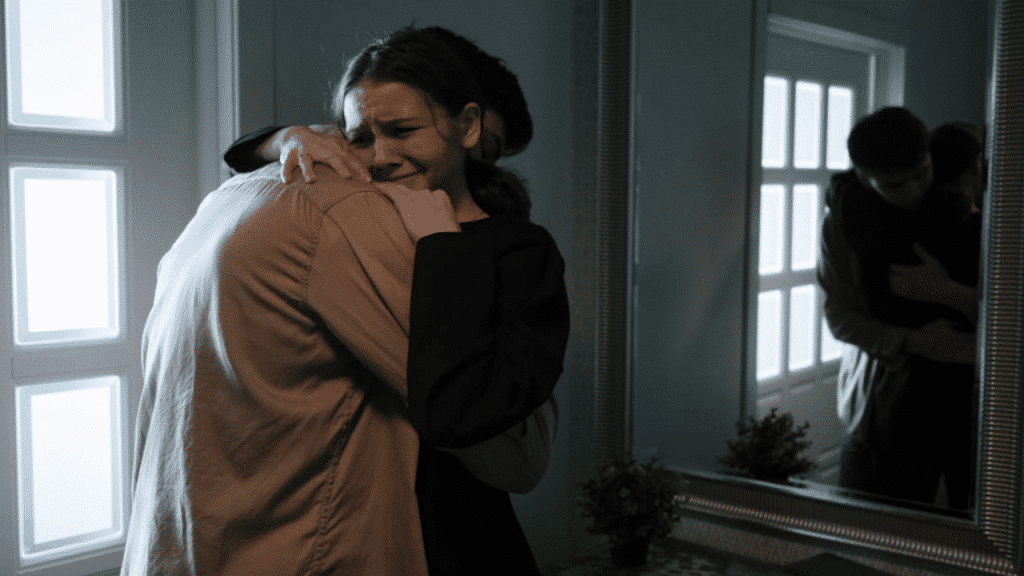 A man comforting his crying wife