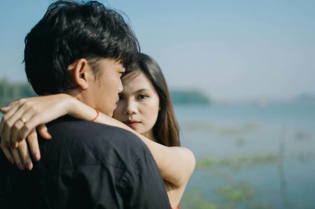 A woman hugging a man