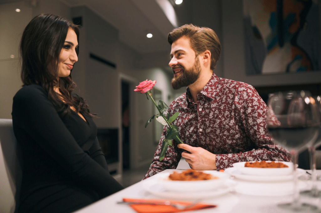 A man giving flower to woman