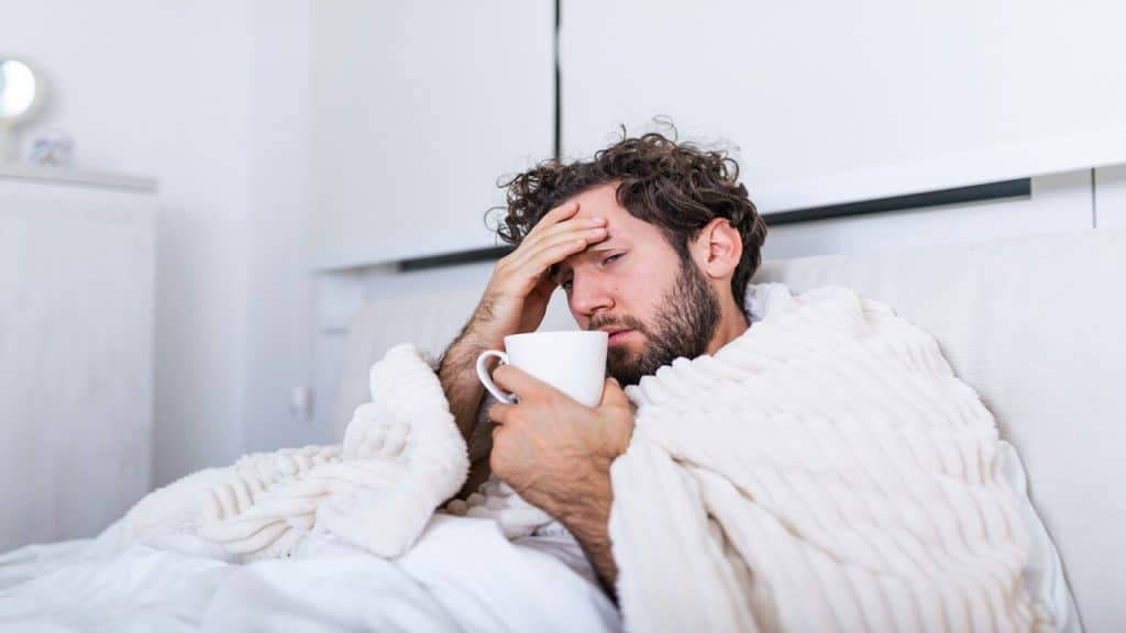 A man sick in bed by himself 