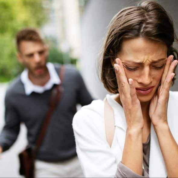 A man and woman arguing outside