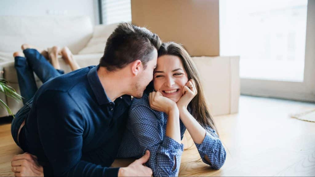 Man kissing woman’s head
