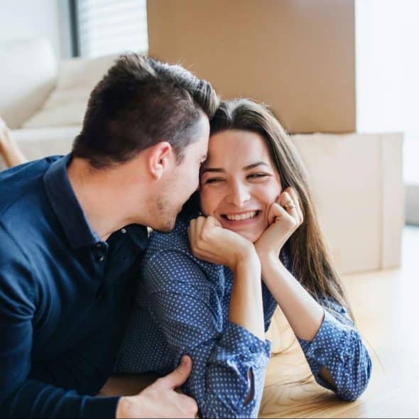 Man kissing woman’s head