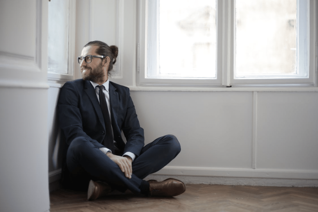 A man smiling while sitting on the floor