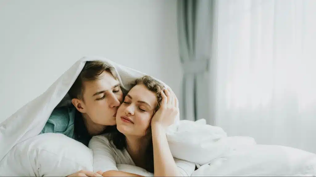 A man kissing woman’s cheeks