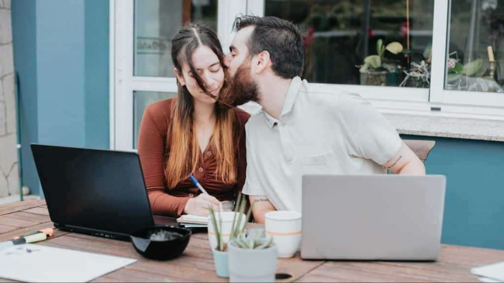 A man kissing woman’s cheeks to support 