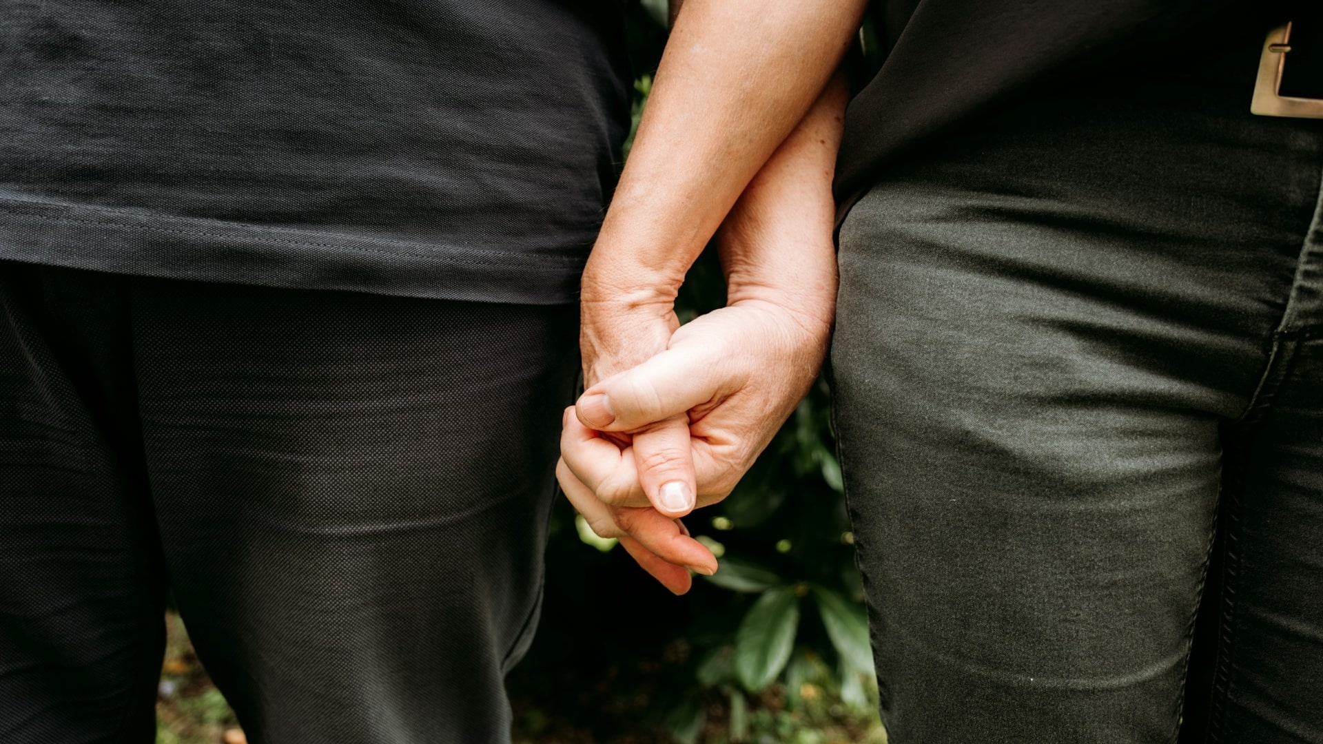 couple holding hands quietly