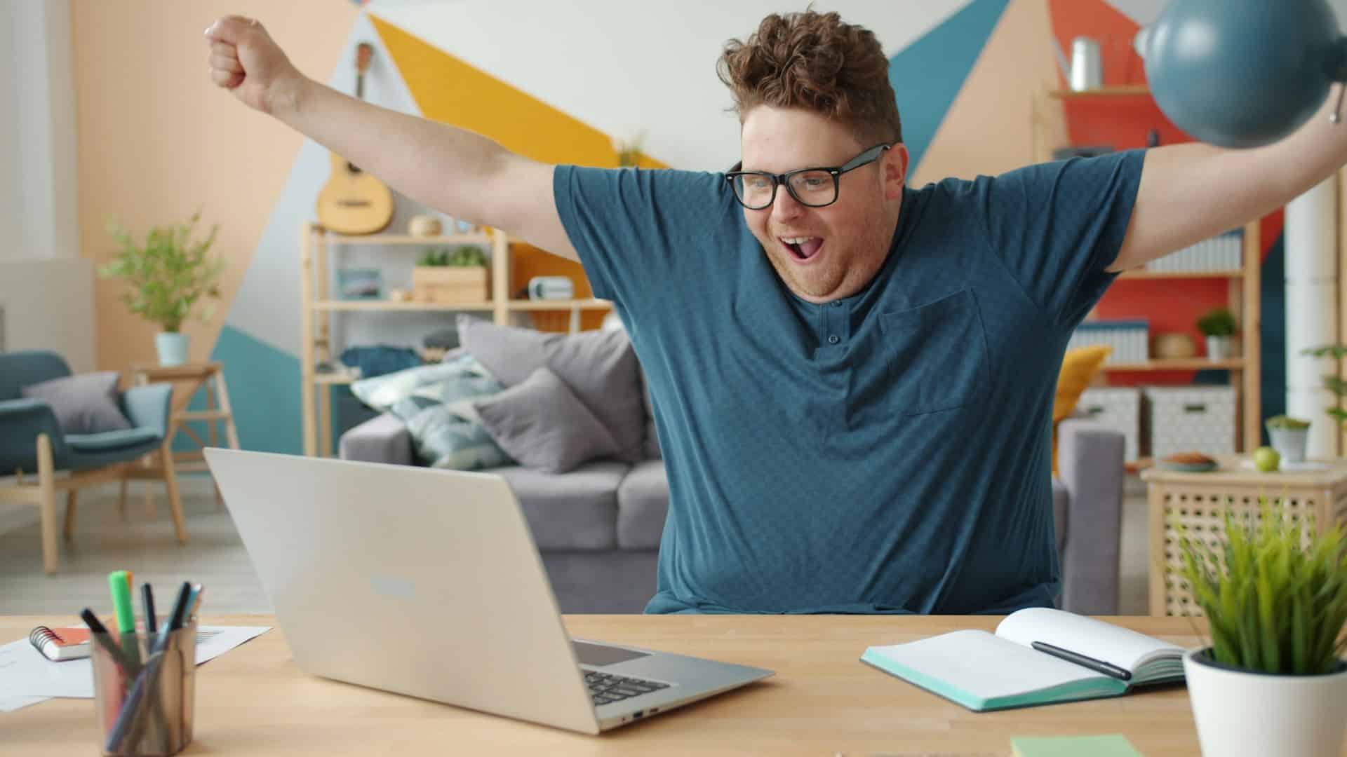 man closing laptop at home