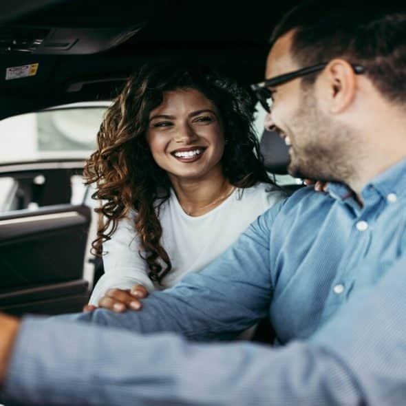 A couple laughing in the car