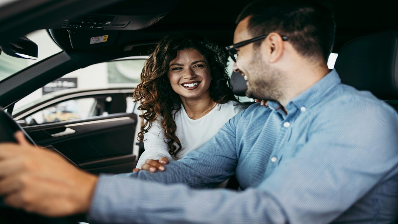 A couple laughing in the car