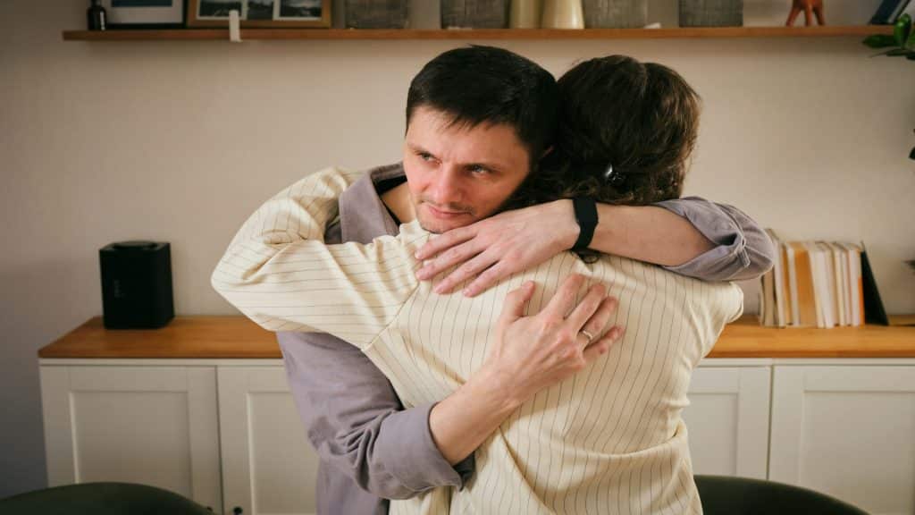 man comforting partner during difficult moment