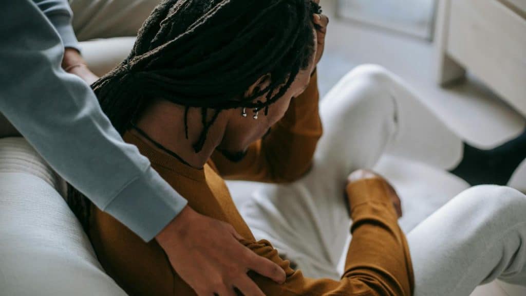 A person sitting with their head down