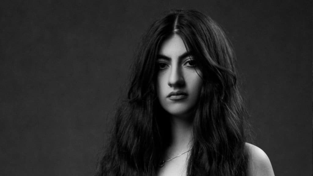 A grayscale image of a woman with open hair.
