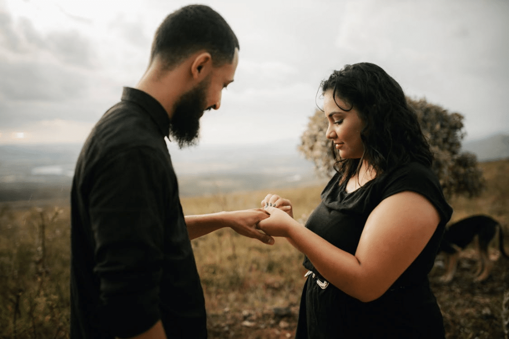 A Woman in Black Dress Holding Hands of Her Partner