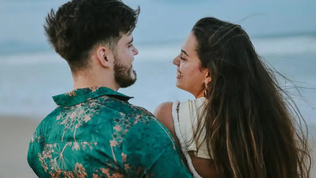 A couple smiling at each other 