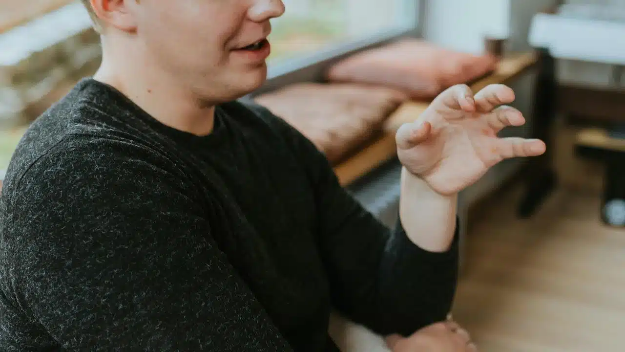A man gesturing with his hand
