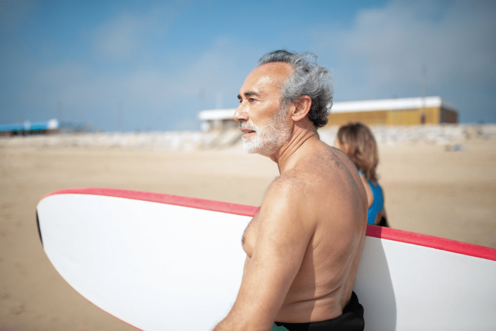 A man carrying a surfboard