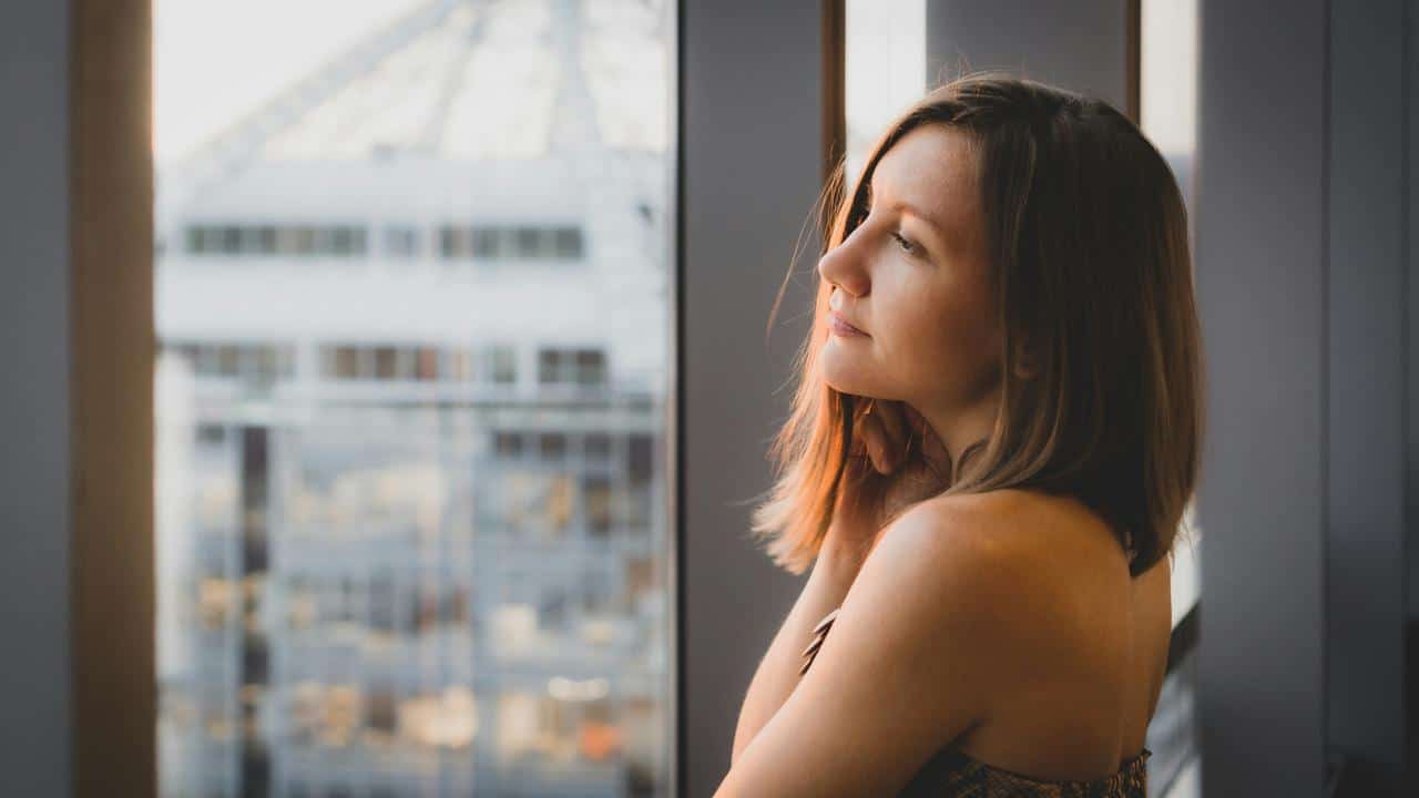 A woman standing by a window