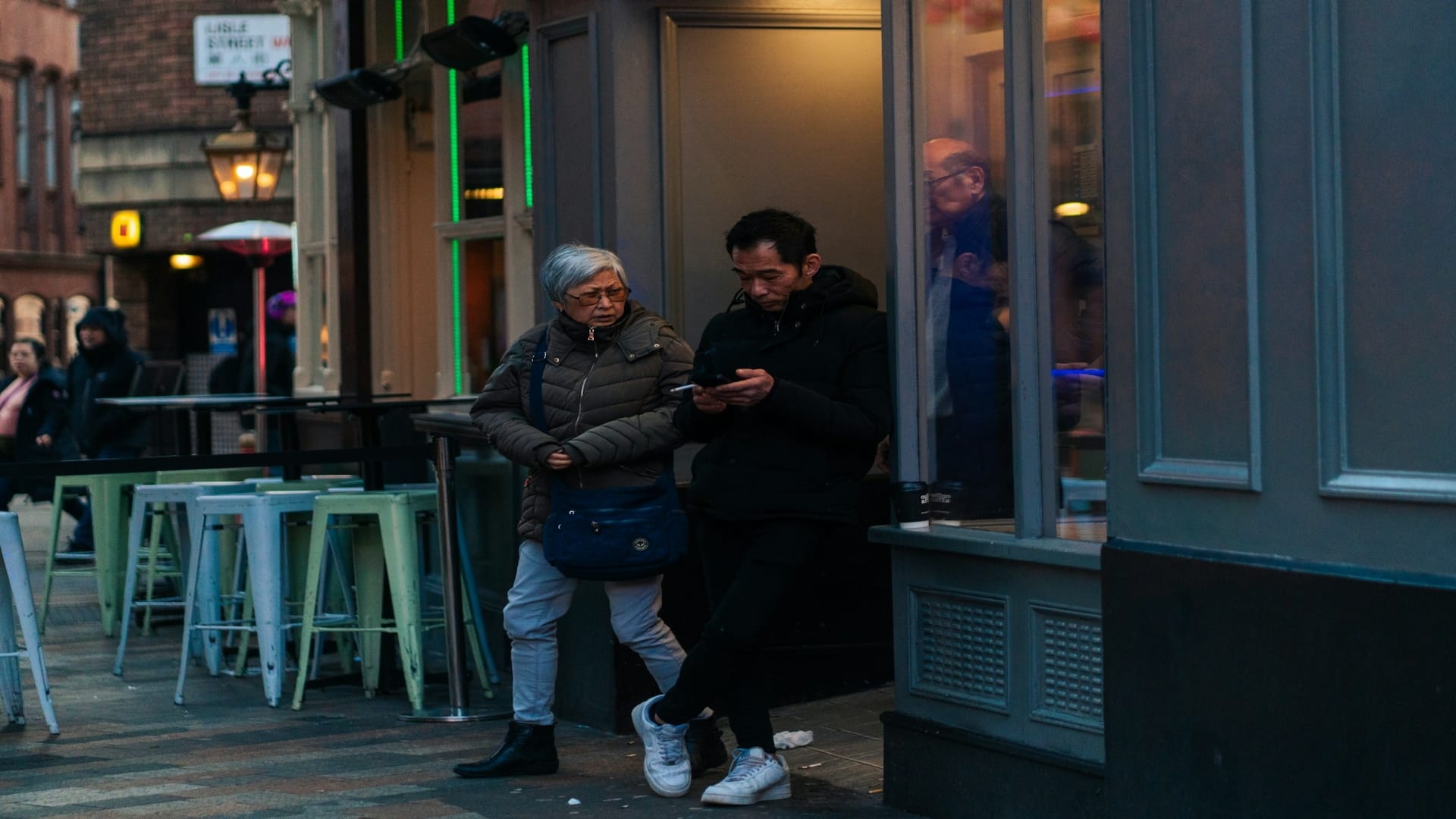 man texting while the other is waiting