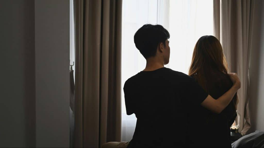 A man cuddling woman