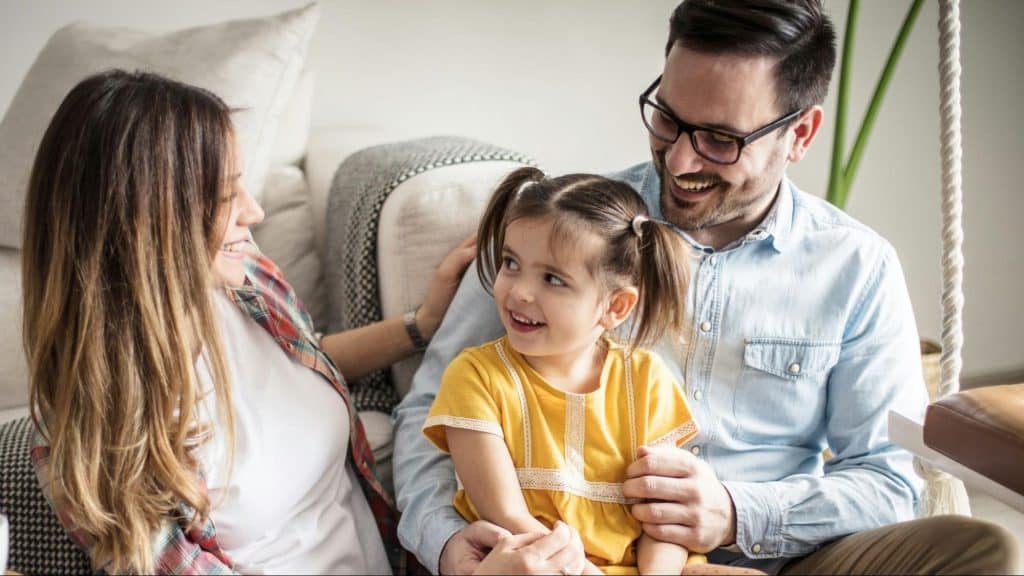 A man and woman at home with their child